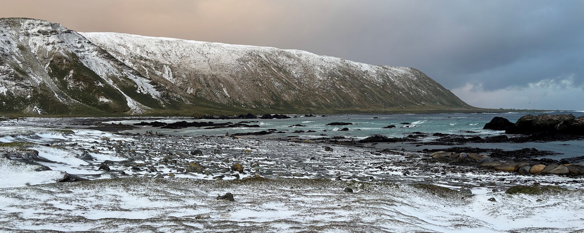 A snow-covered plateau in the distance, a snow-covered beach in the foreground.