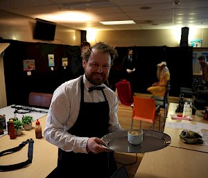 man holding coffee on silver tray