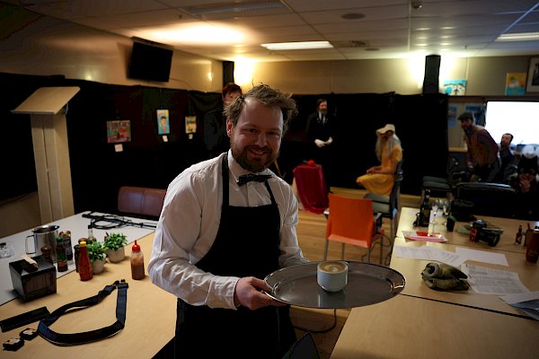 man holding coffee on silver tray