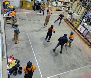 Playing volleyball in a shed inside