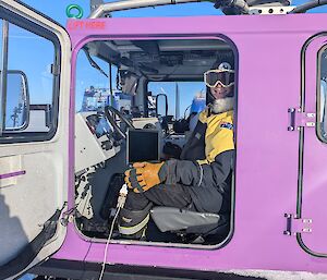 An expeditioner sitting in a Hagg with electronic equipment