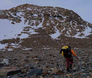 people hiking toward a hill