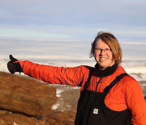 man giving thumbs up on top of hill