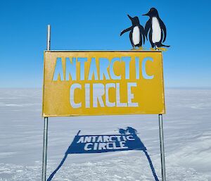 A refurbished Antarctic Circle sign, with a fresh coat of yellow paint.