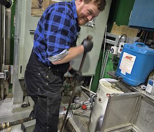 A plumber plunging a blocked drain