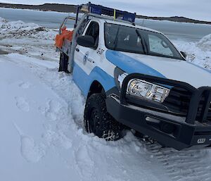 A ute parked on an angle in the snow