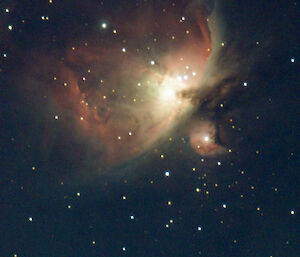 Clouds of gas and dust in the Orion Nebula in the night sky
