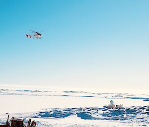 A helicopter in the sky over Casey station