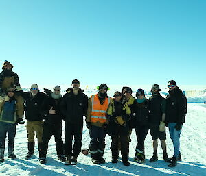 The Casey team awaiting arrival of the helicopters standing in a group together