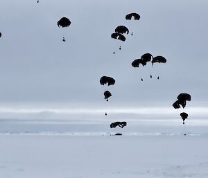 Parachutes falling from the sky onto the ice
