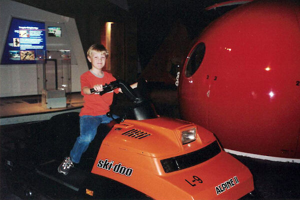 boy sitting on skidoo