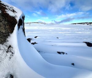 Wind scours with snow and ice in the background +