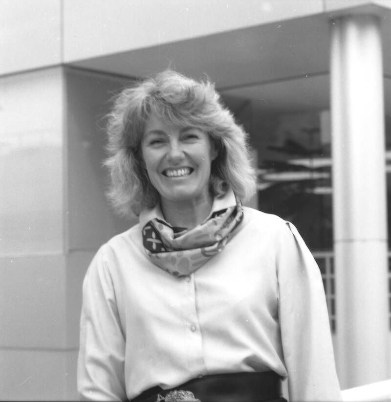 A smiling woman standing outside a building at the Antarctic Division's headquarters in Tasmania.