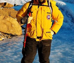 A person rugged up against the cold standing on a frozen lake