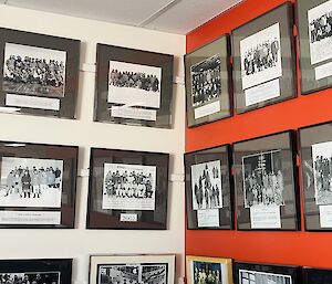 Two walls covered in framed team photos