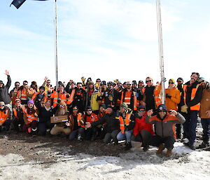 A group of people in high vis clothing in a group smiling