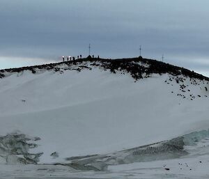 People on a hill setting off flares