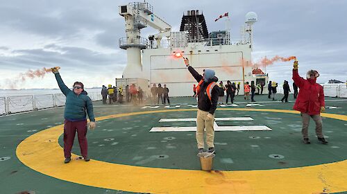 Three people set off flares on the helideck on RSV Nuyina