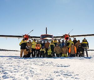 A group photo of Mawson expeditioners in front of a Twin Otter aircraft on the Mawson skiway