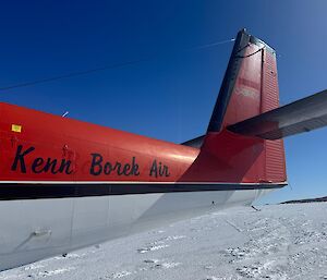The tail end of a Twin Otter aircraft with 'Kenn Borek Air' written on the side.