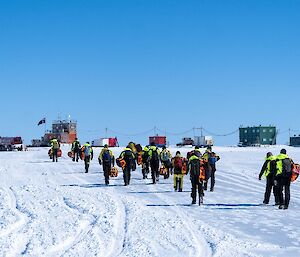 Expeditioners walking across the ice runway