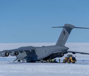 Heavy equipment being unloaded from a C17 aircraft on the ice runway