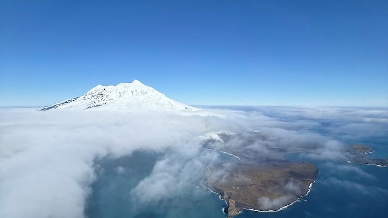Aerial view of Big Ben's peak sitting above cloud