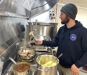A man cooking at a stove