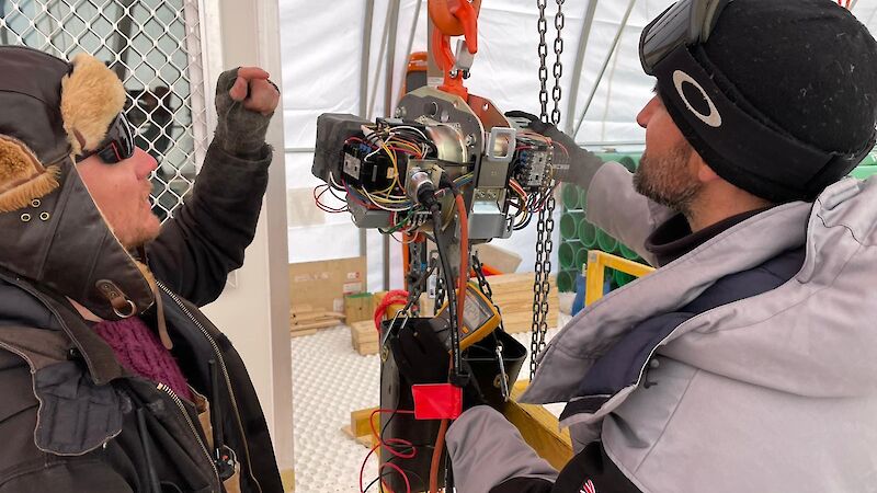 Two people look at some equipment