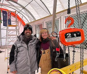 Two men smiling in a large tent