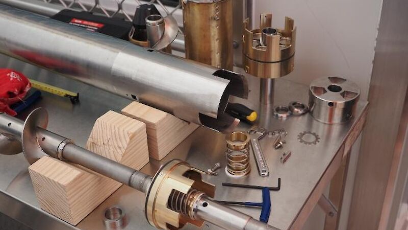 A long silver pipe being worked on