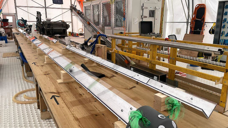 View of two v-shaped metal channels on a wooden bench