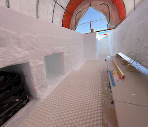 A shelter dug into ice beneath a tent roof, to store ice cores.