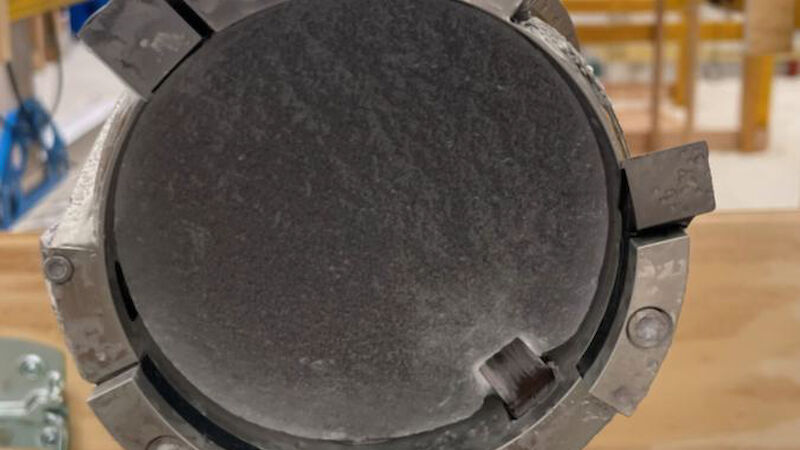 The end of an ice core drilling barrel showing a cutting head