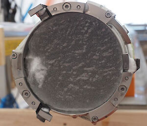 The end of an ice core drilling barrel showing a cutting head