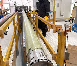 A drill barrel with a valve attachment at its cutting end.