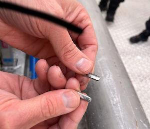 Close up of a tiny piece of broken aluminium.