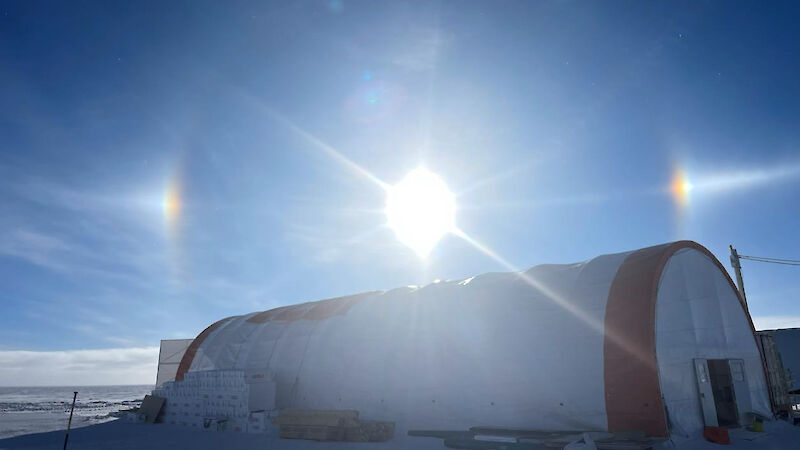 The sun creates a halo effect as it reflects of ice crystals in the dry, cold air over the ice core drilling shelter.