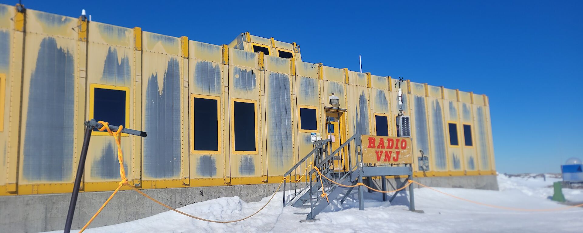 A yellow building with a sign saying "Radio VNJ".