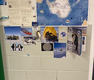 A photo featuring postcards, pictures, a letter, some Antarctic stickers, a map and a sign that reads' Guess who called from Antarctica! Josh!'