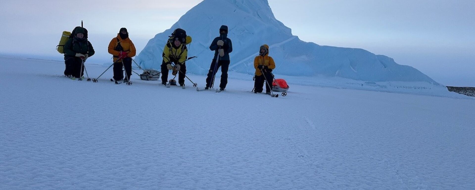 Five expeditioners skiing in Antarctica.
