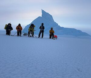 Five expeditioners skiing in Antarctica.