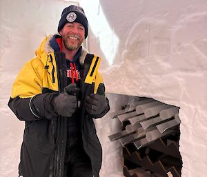 Josh stands next to some of the ice cores