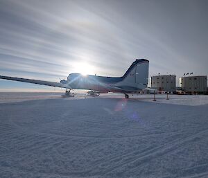 A photo of an Antarctic plane with the station in the background