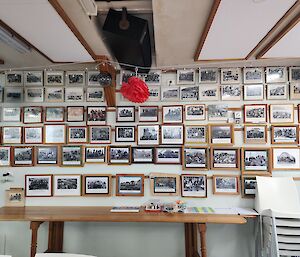 A wall adorned with dozens of team photographs of wintering expeditioners from Macquarie Island since it opened.