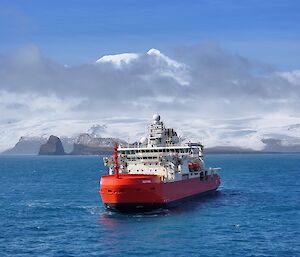 RSV Nuyina offshore of the snow-covered Heard Island.